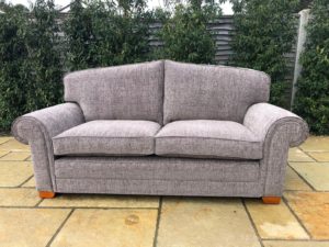 A large 3-seater Wade settee recovered and reupholstered in grey chenille - with brand-new seat and cushions