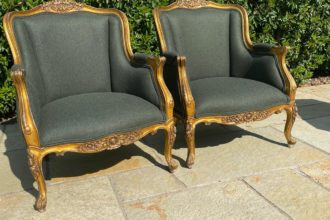 A pair of French gilt armchairs recovered in a Laura Ashley wool fabric