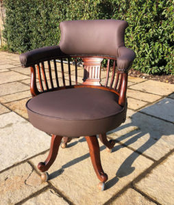 A very old captains chair, totally restored and recovered in brown leather
