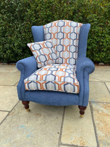A quality winged arm chair recovered in a Fryett fabric