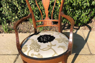 A before and after of a small chair recovered and reupholstered
