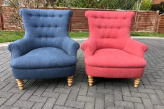 A pair of buttoned armchairs recovered in pink and blue Linwood fabrics