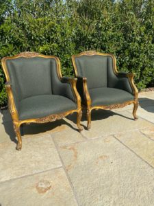 A pair of French gilt armchairs recovered in a Laura Ashley wool fabric