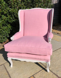 American winged back chair recovered in pink linen with new fibre filled seat cushion