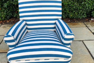 Armchair cover in strip fabric